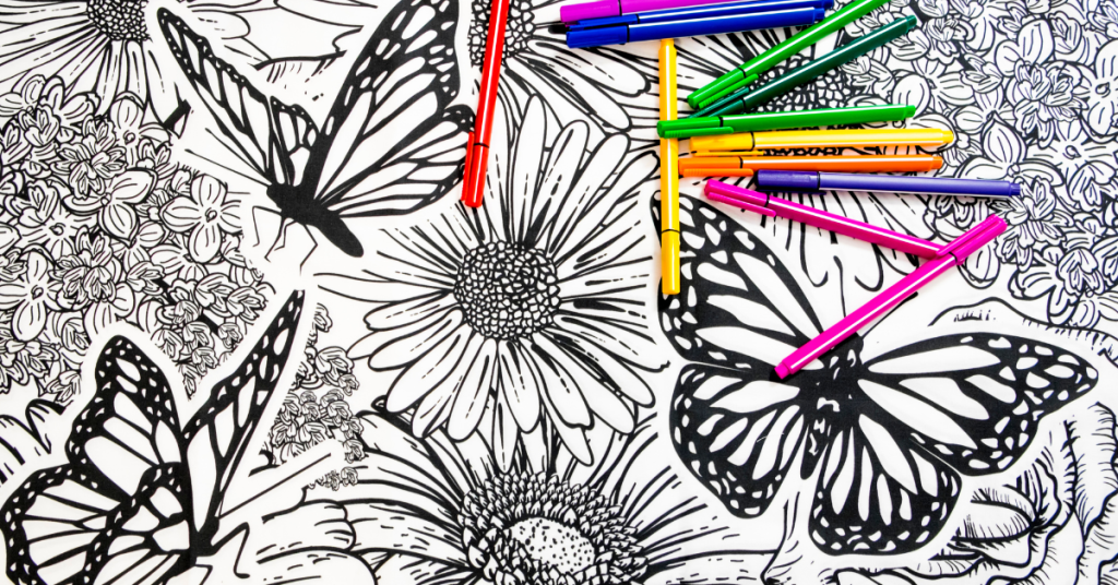 coloring page of butterflies and flowers in black and white with coloring pens on it.